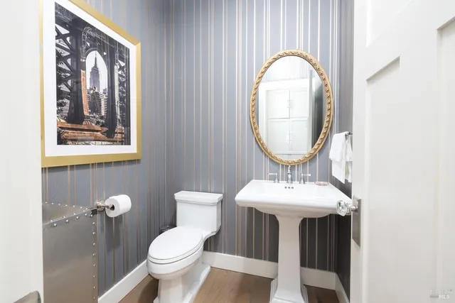 a bathroom with a toilet sink and mirror