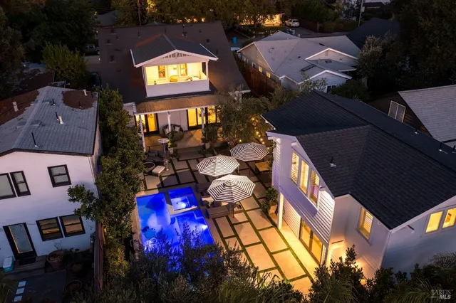 an aerial view of multiple houses with a yard