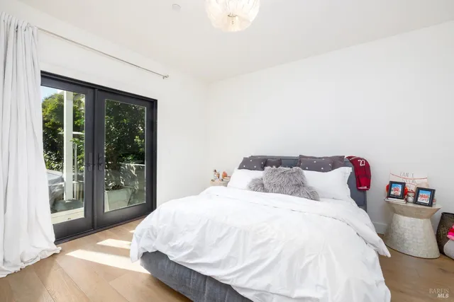 a bedroom with a bed and a large window