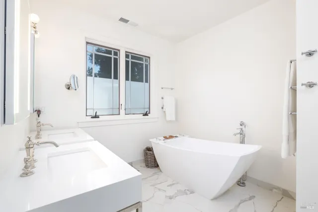 a bathroom with a bathtub and a sink