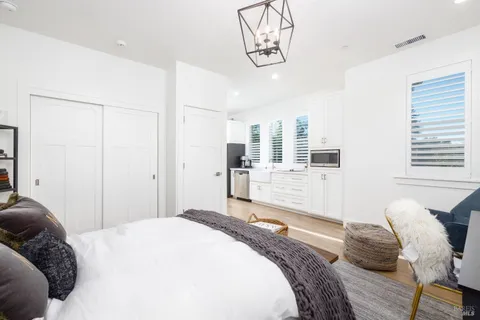 a bedroom with a bed and glass windows