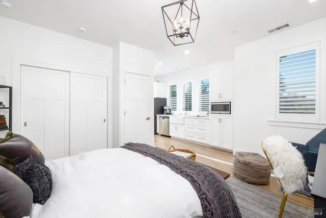 a bedroom with a bed and glass windows