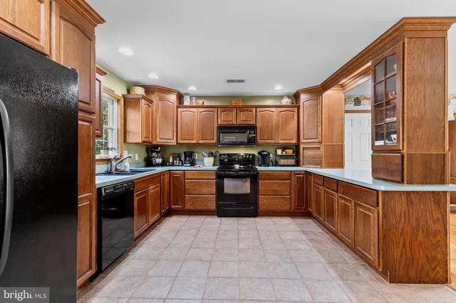 a kitchen with stainless steel appliances granite countertop a stove and a microwave