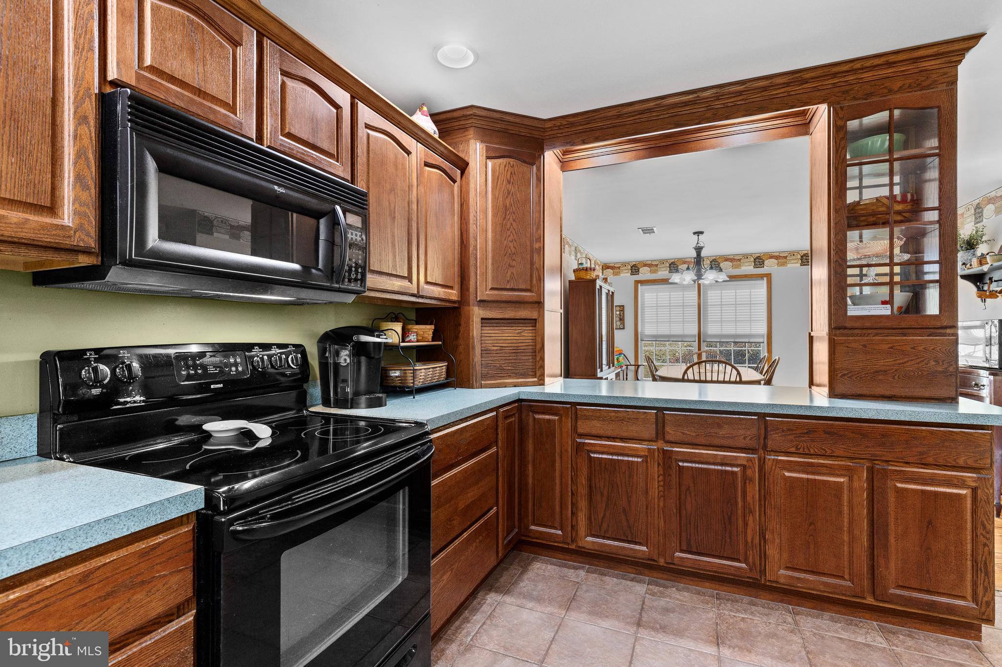 14731 Shimpstown Road Mercersburg, PA 17236 - Photo 15 of 52 a kitchen with stainless steel appliances granite countertop a stove and a microwave