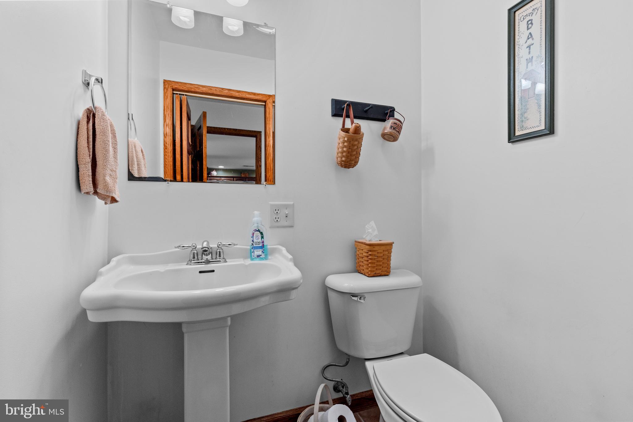 14731 Shimpstown Road Mercersburg, PA 17236 - Photo 17 of 52 a bathroom with a toilet sink and mirror