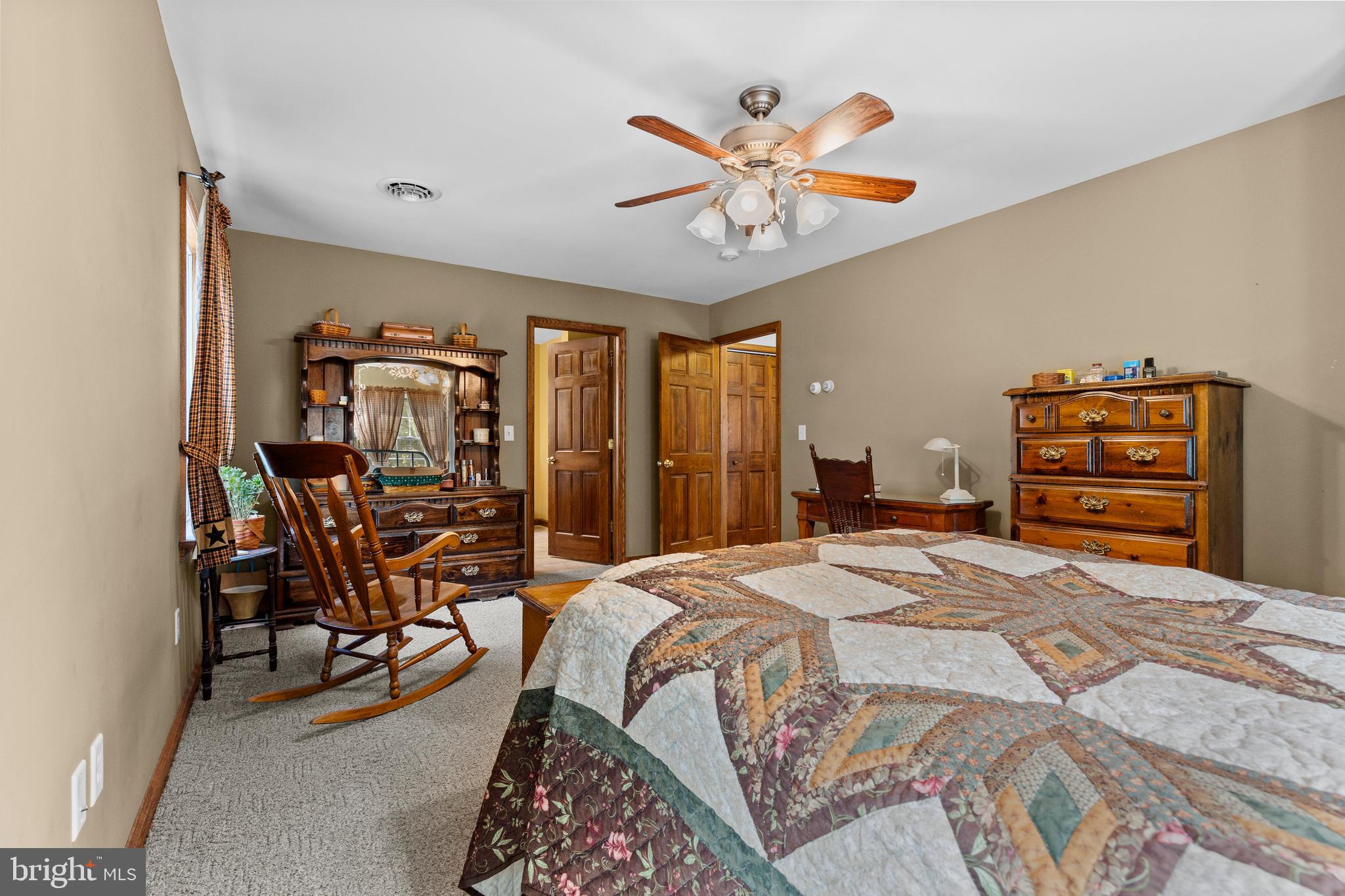 14731 Shimpstown Road Mercersburg, PA 17236 - Photo 23 of 52 a bedroom with a bed a chandelier and dresser