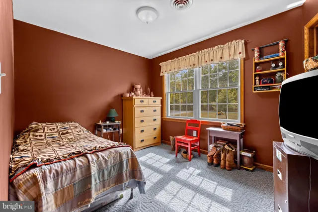 a bedroom with a bed and a flat tv screen