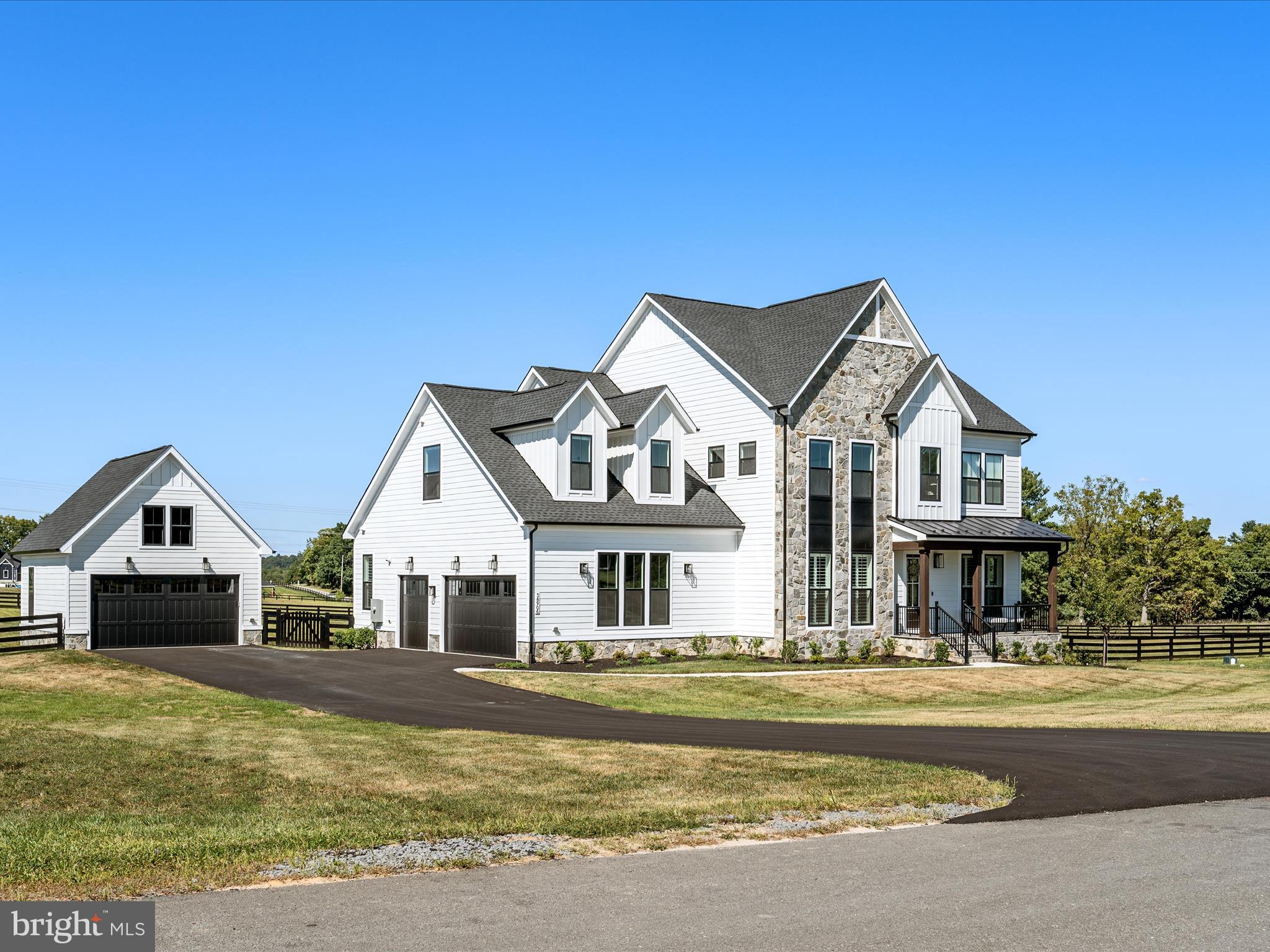 a front view of a house with a yard outdoor seating and garage