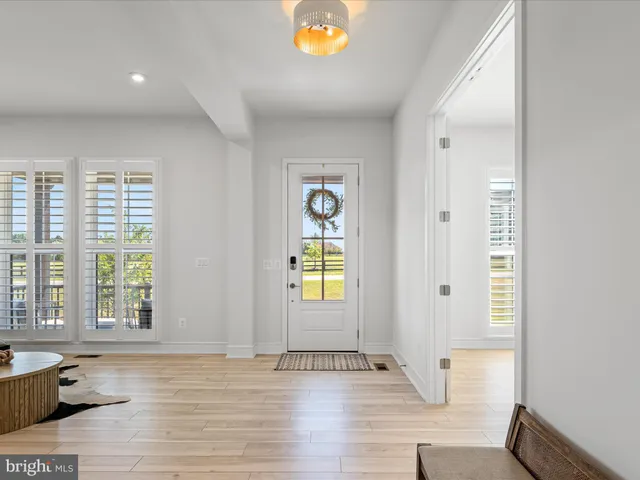 a view of a workspace with furniture and wooden floor