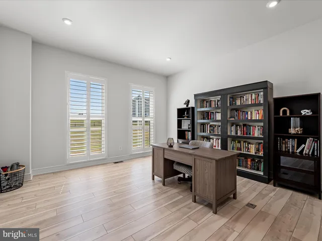 a kitchen with stainless steel appliances kitchen island granite countertop a table chairs and a refrigerator