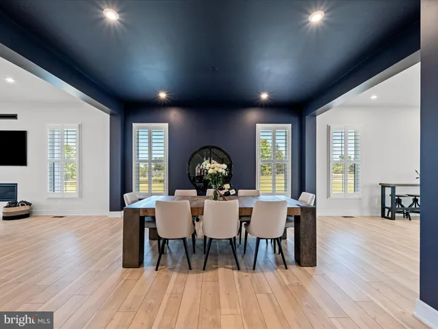 a kitchen with stainless steel appliances granite countertop a coffee maker a sink and white cabinets