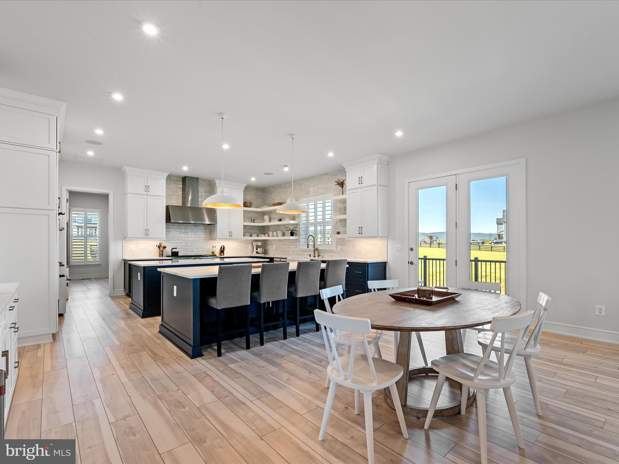 38906 Rumely Way Waterford, VA 20197 - Photo 26 of 99 a kitchen with stainless steel appliances kitchen island granite countertop a table chairs and a refrigerator