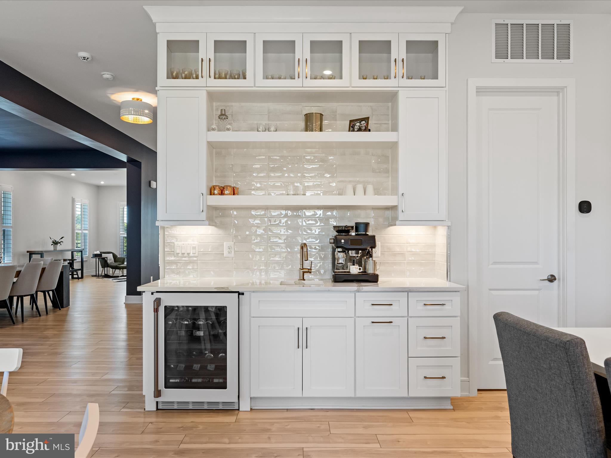 38906 Rumely Way Waterford, VA 20197 - Photo 28 of 99 a kitchen with stainless steel appliances granite countertop a coffee maker a sink and white cabinets
