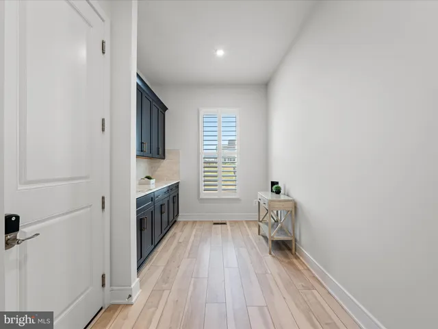 a large bedroom with a large bed and a flat tv screen on dresser