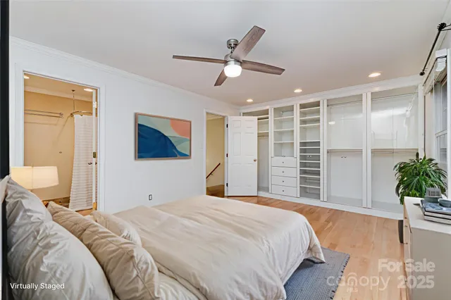 a bedroom with a large bed and a chandelier