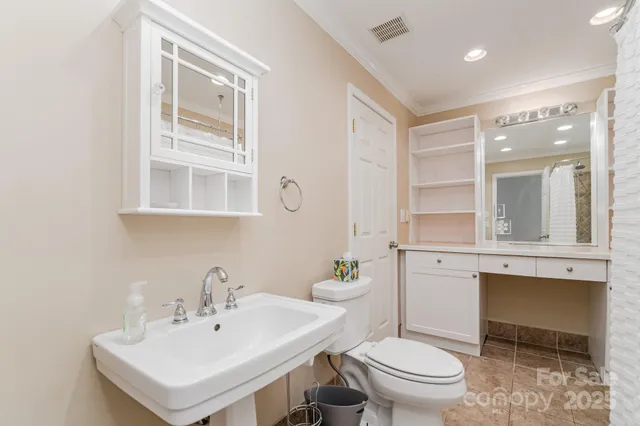 a bathroom with a sink toilet and mirror