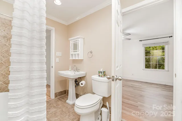 a bathroom with a toilet a sink and a mirror