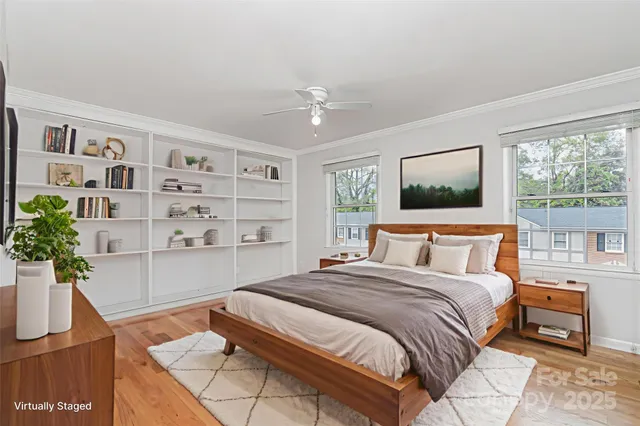 a bedroom with a bed and a potted plant
