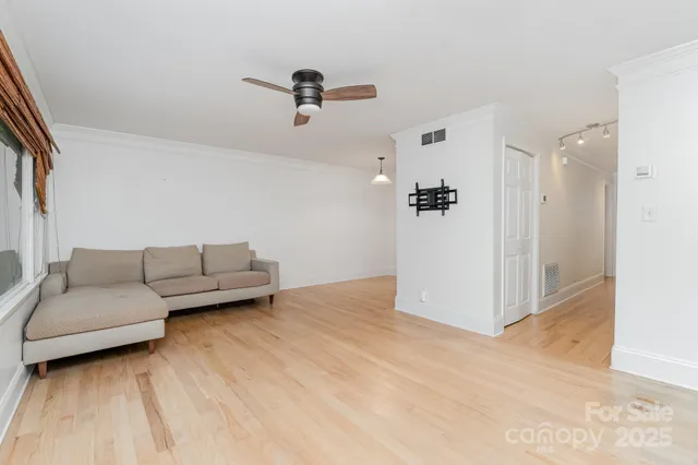 a living room with furniture and a ceiling fan