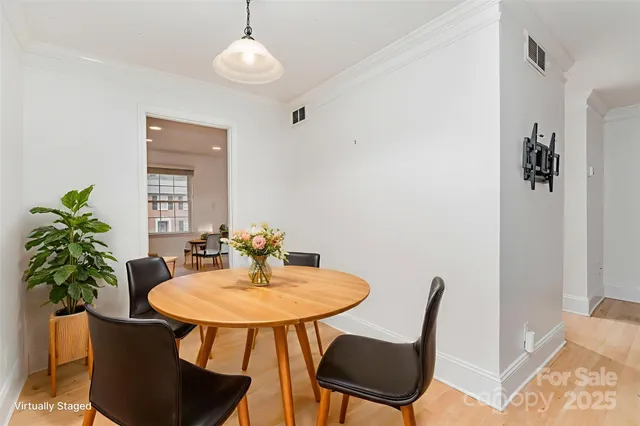 a dining room with furniture and wooden floor