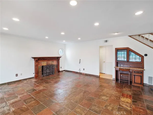 a view of an empty room with kitchen