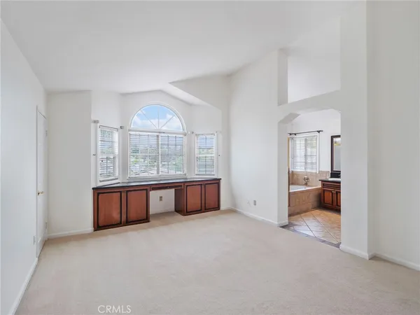 an empty room with a fireplace and a window