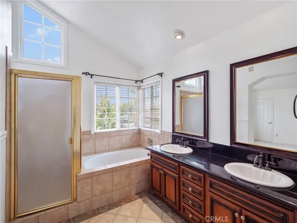 a bathroom with a sink and a mirror with bathtub