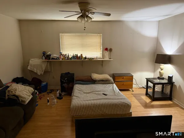 a bedroom with a bed and window