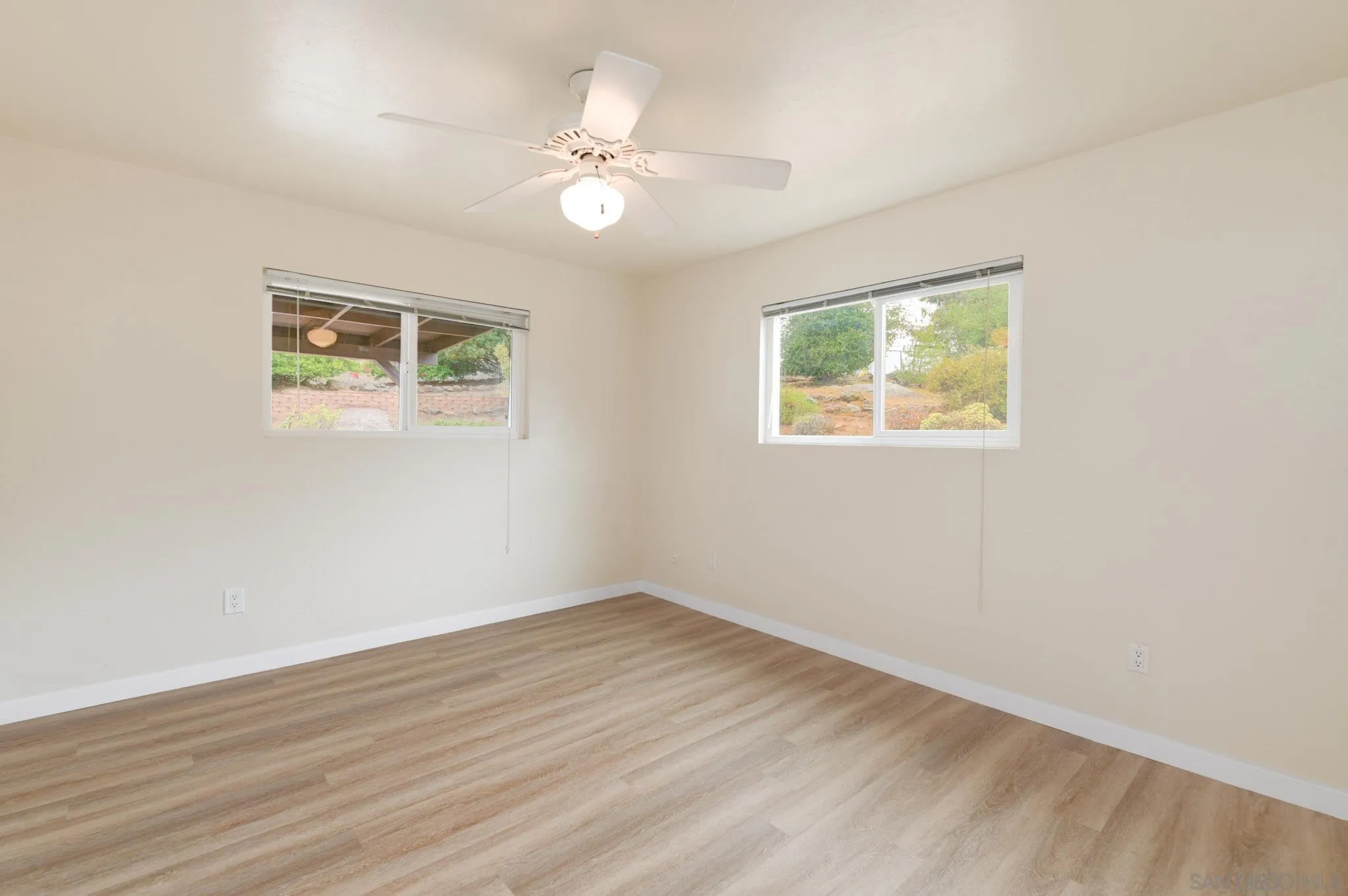 1961 Pine View Road Alpine, CA 91901 - Photo 21 of 35 a view of an empty room with wooden floor and a window