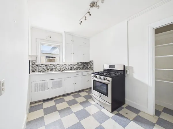 a kitchen with a stove a sink and a refrigerator