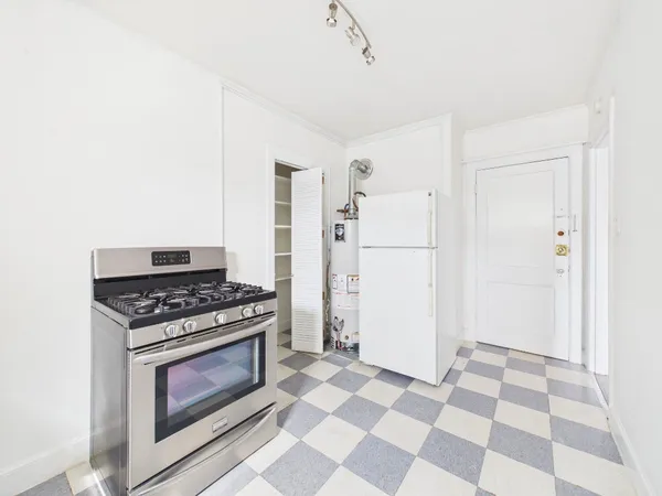 a kitchen with a stove and a refrigerator