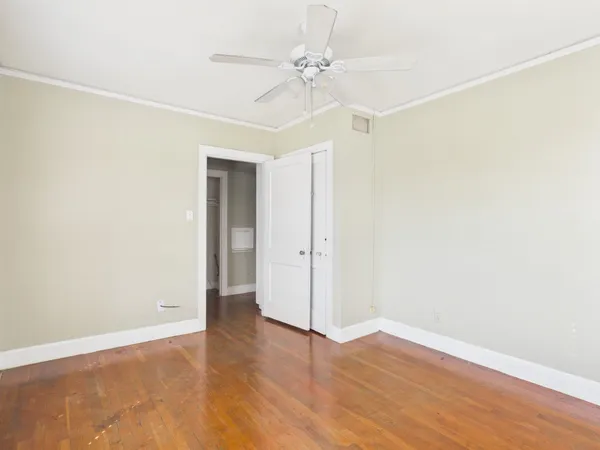 a view of an empty room with wooden floor
