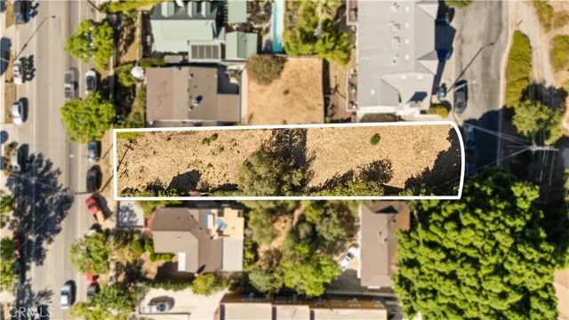 an aerial view of multiple houses with yard