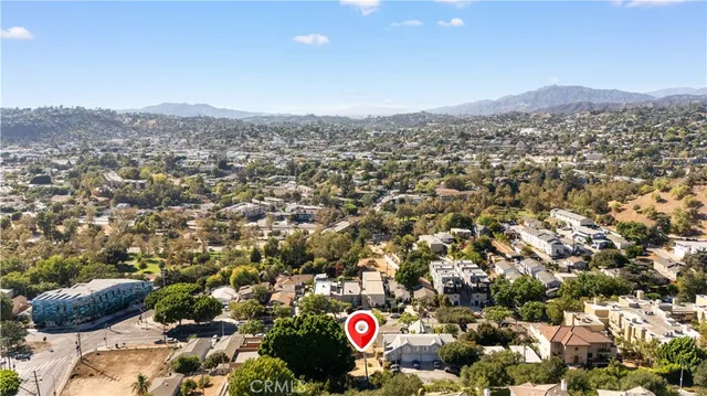 an aerial view of residential building and trees around