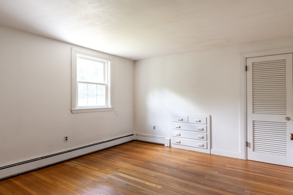 21 Ortins Road Hamilton, MA 01982 - Photo 13 of 16 an empty room with wooden floor and windows