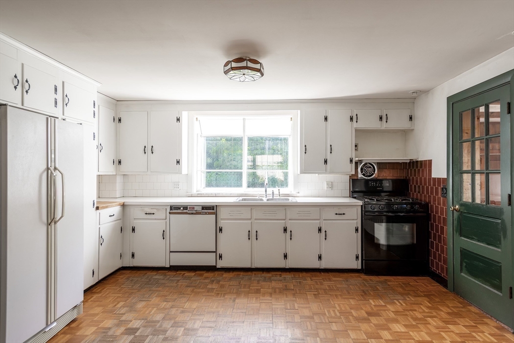 21 Ortins Road Hamilton, MA 01982 - Photo 4 of 16 a large kitchen with a refrigerator a stove top oven a sink and dishwasher