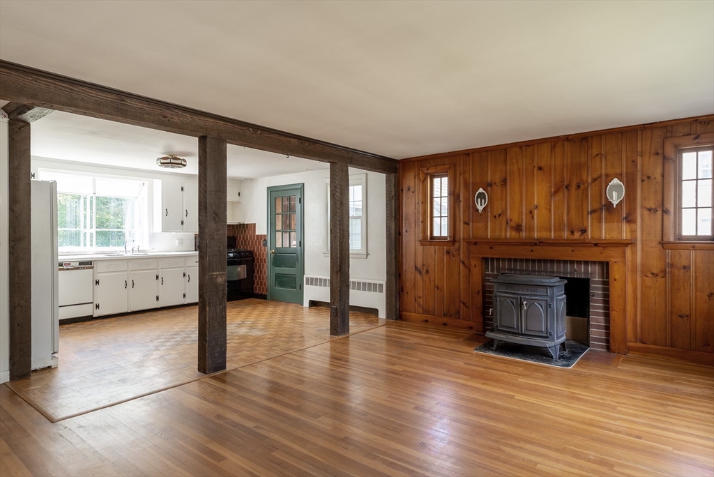21 Ortins Road Hamilton, MA 01982 - Photo 5 of 16 a view of a livingroom with wooden floor and a fireplace