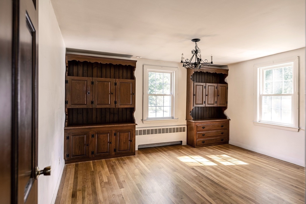 21 Ortins Road Hamilton, MA 01982 - Photo 8 of 16 a view of a livingroom with furniture wooden floor windows and cabinet