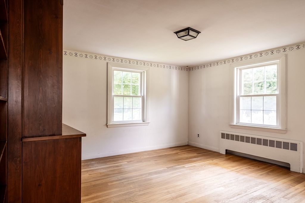 21 Ortins Road Hamilton, MA 01982 - Photo 10 of 16 a view of an empty room with wooden floor and a window