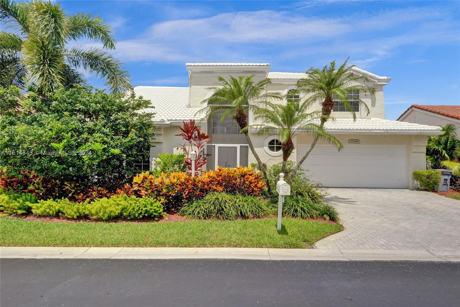 17269 Balboa Point Way Boca Raton, FL 33487 - Photo 1 of 41 a view of a garden with a building in the background