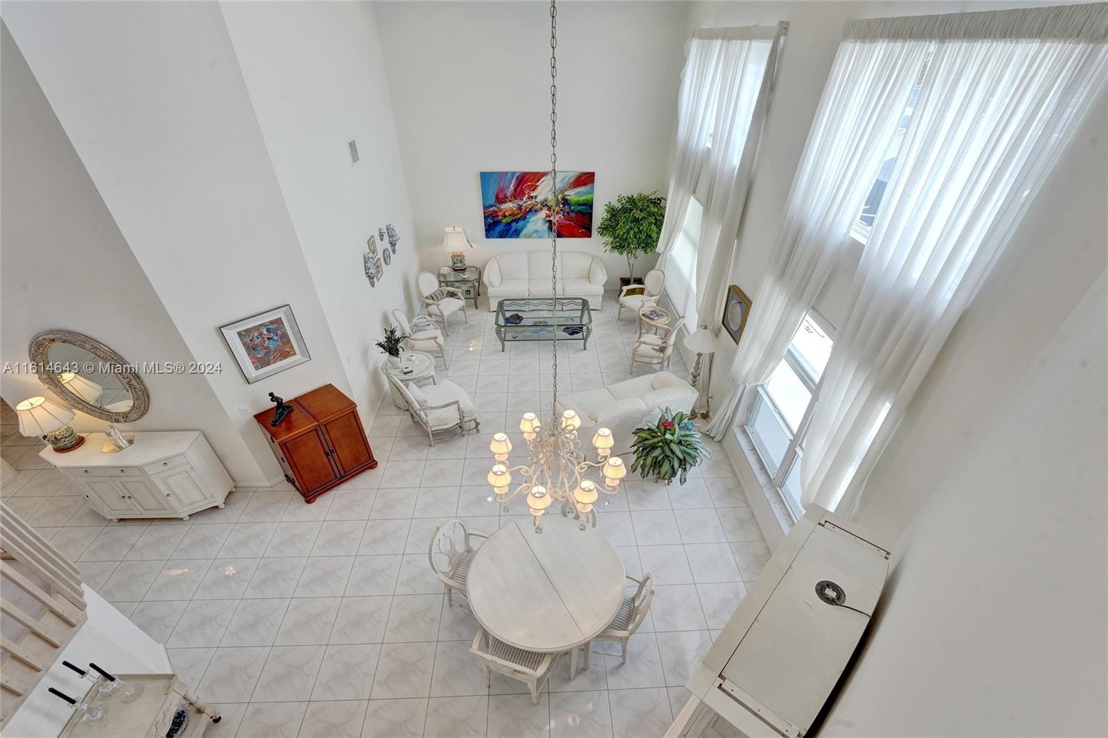 17269 Balboa Point Way Boca Raton, FL 33487 - Photo 11 of 41 a living room with furniture and a chandelier