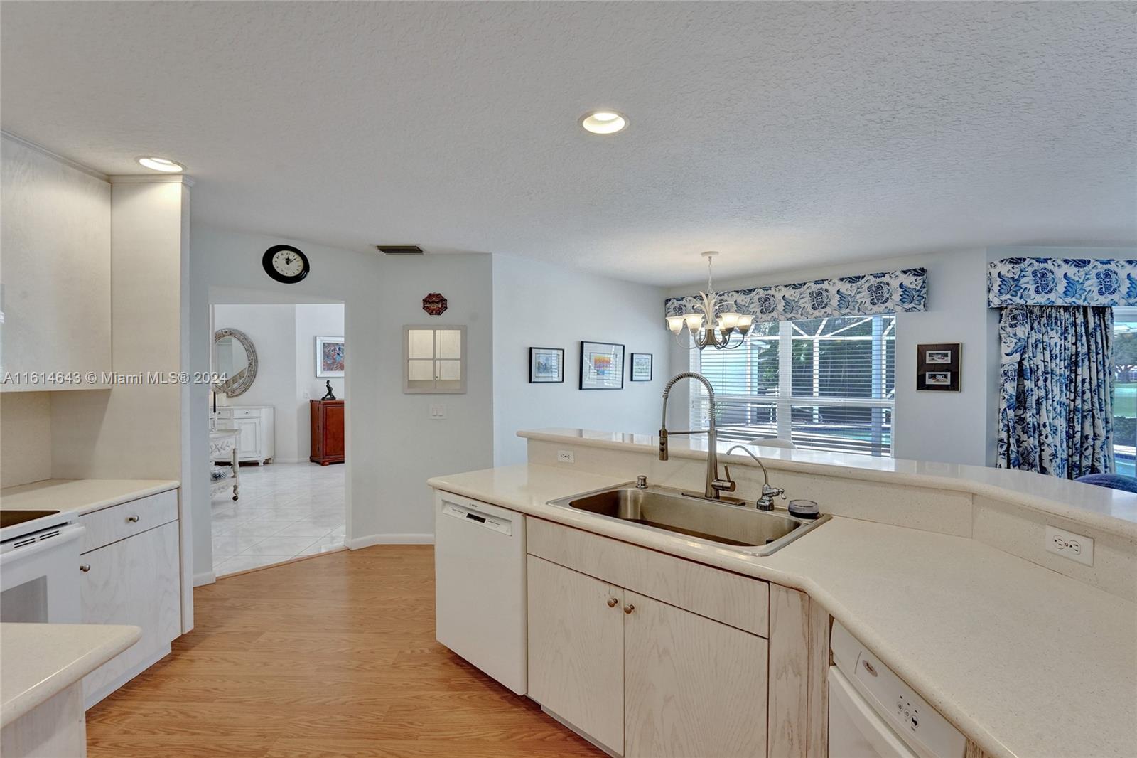 17269 Balboa Point Way Boca Raton, FL 33487 - Photo 15 of 41 a kitchen with sink cabinets and living room view