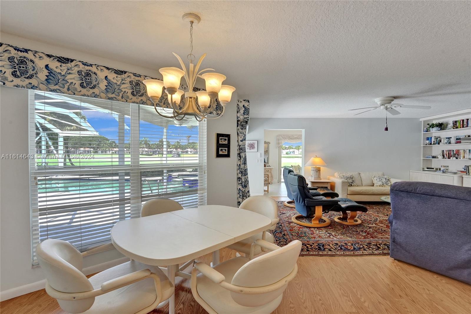 17269 Balboa Point Way Boca Raton, FL 33487 - Photo 20 of 41 a living room with couches a dining table and chairs with outer view