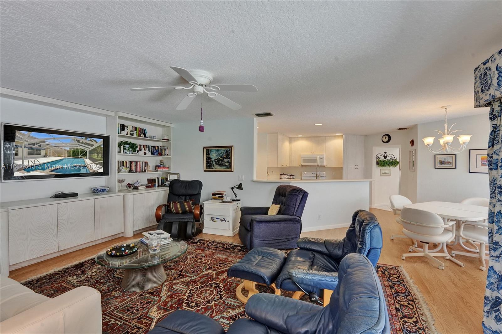 17269 Balboa Point Way Boca Raton, FL 33487 - Photo 21 of 41 a living room with furniture and a flat screen tv