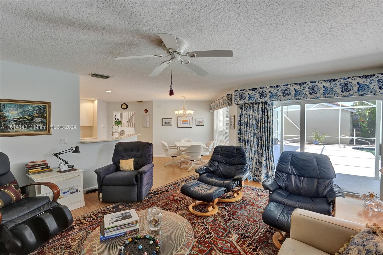 17269 Balboa Point Way Boca Raton, FL 33487 - Photo 22 of 41 a living room with furniture ceiling fan and a window