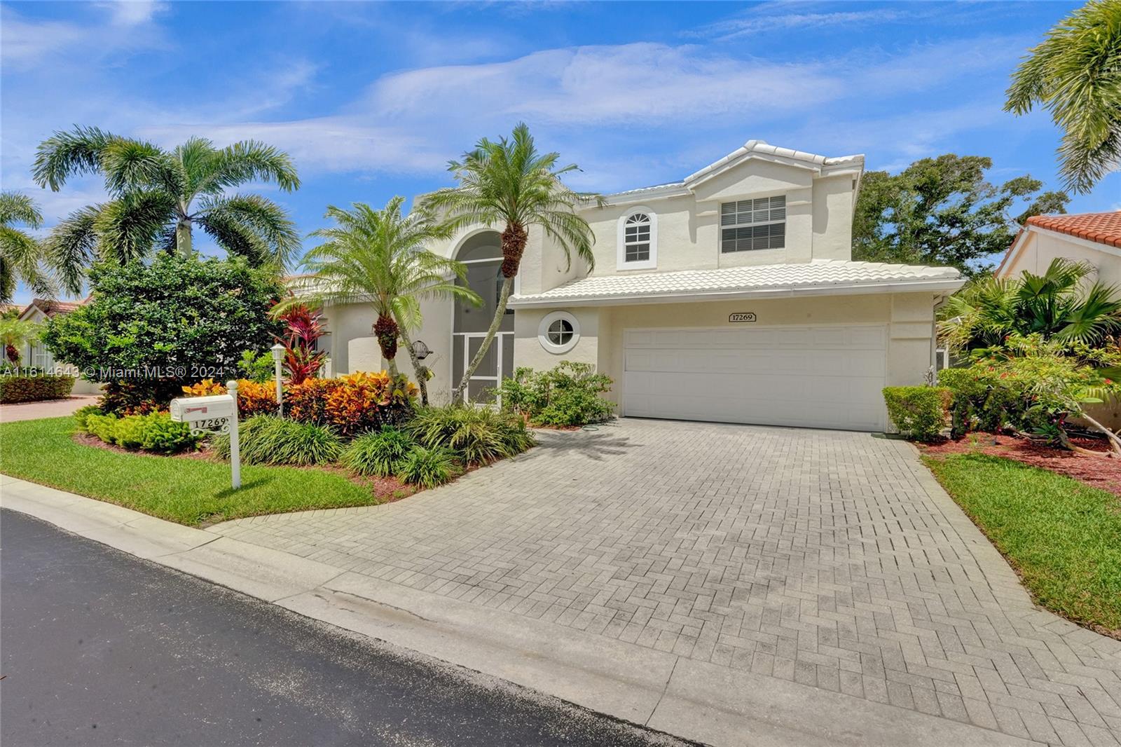 17269 Balboa Point Way Boca Raton, FL 33487 - Photo 3 of 41 a front view of a house with a garden