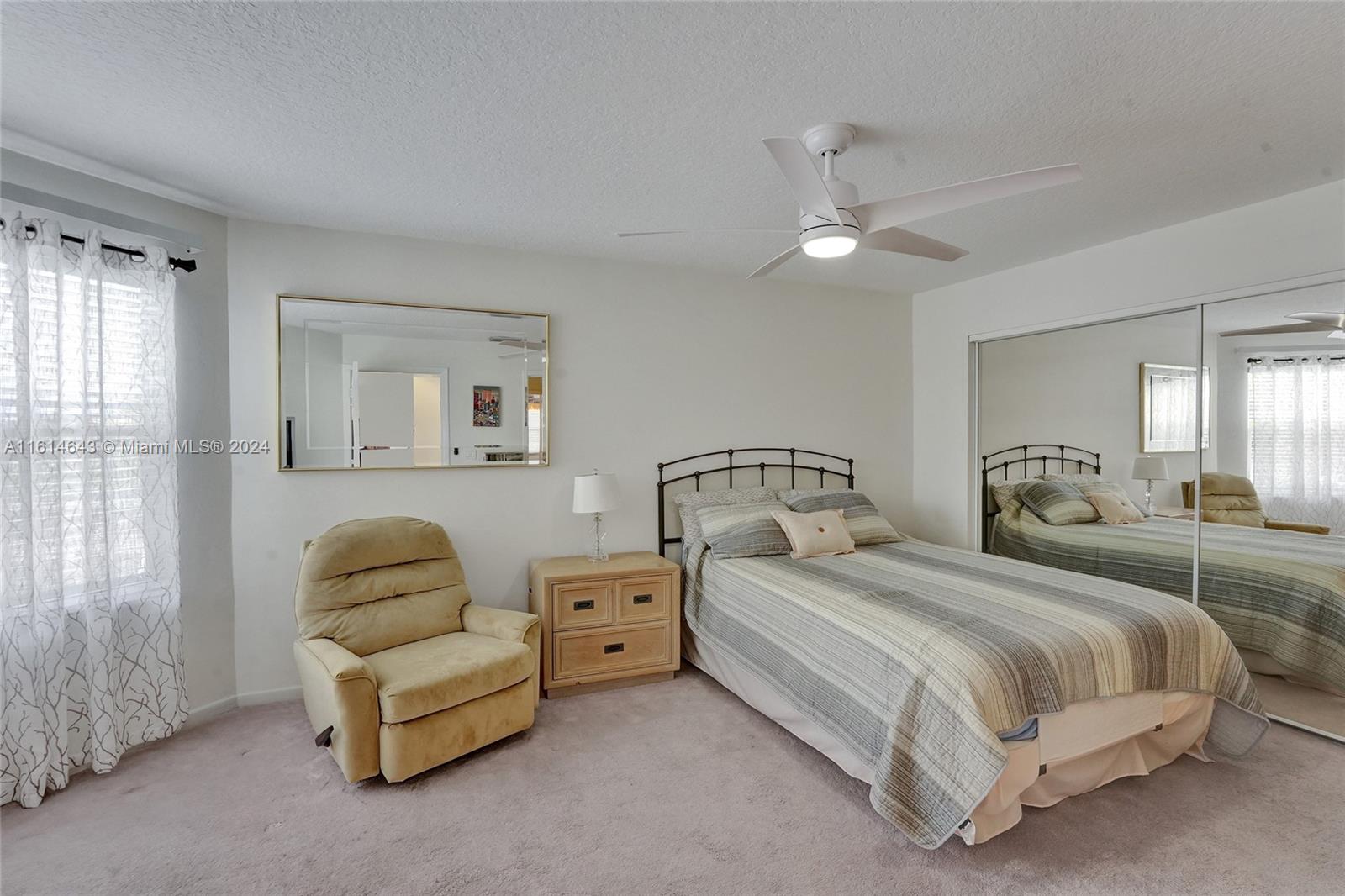 17269 Balboa Point Way Boca Raton, FL 33487 - Photo 32 of 41 a bedroom with bed lamp and window