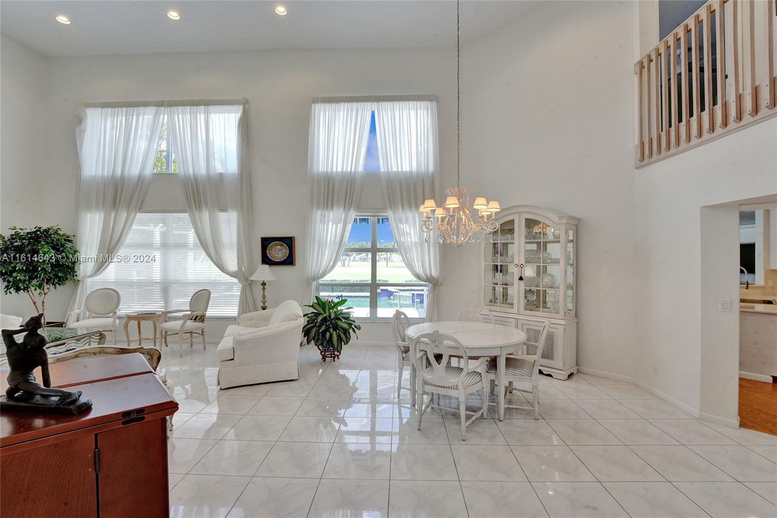17269 Balboa Point Way Boca Raton, FL 33487 - Photo 7 of 41 a living room with furniture a chandelier and a table