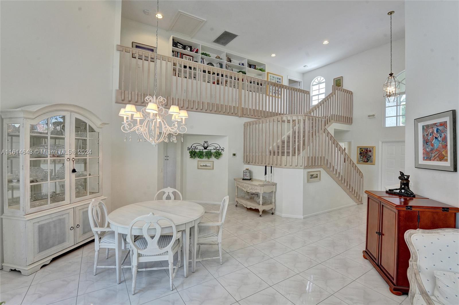17269 Balboa Point Way Boca Raton, FL 33487 - Photo 8 of 41 a dining room with furniture a chandelier and window