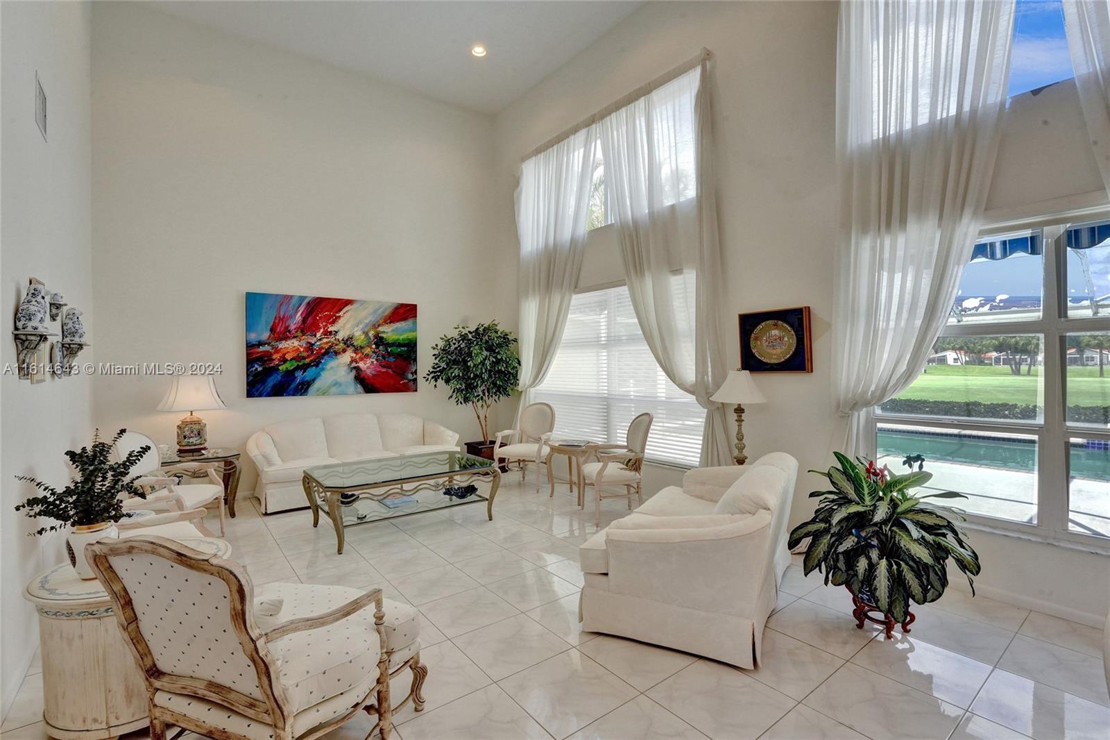 17269 Balboa Point Way Boca Raton, FL 33487 - Photo 9 of 41 a living room with furniture and a large window